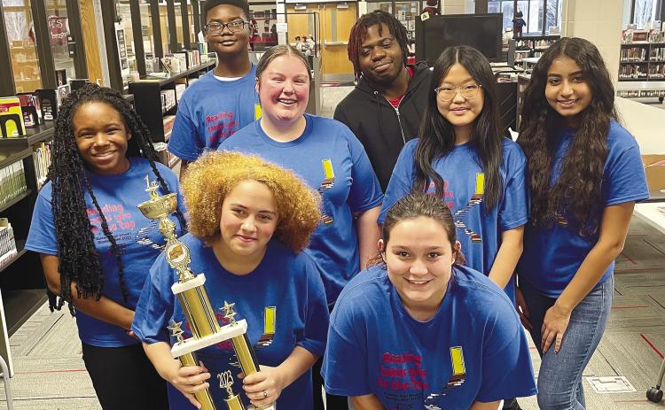 Row 1: Ansley Milam, Rachel Brooks, Row 2: Trinity Stephens, Kaitlin Teague, Yan Yang, Ayesha Patel, and Row 3 Joshua Wright, Shatavious Hamm hold the region championship trophy. CONTRIBUTED
