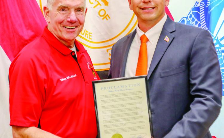 Baldwin County Board of Commissioners Chairman Andrew Strickland (right) presented GMC president Lt. Gen. William B. Caldwell IV with a proclamation thanking him for his service to the school and the county for the last 12 years. COURTESY OF GMC