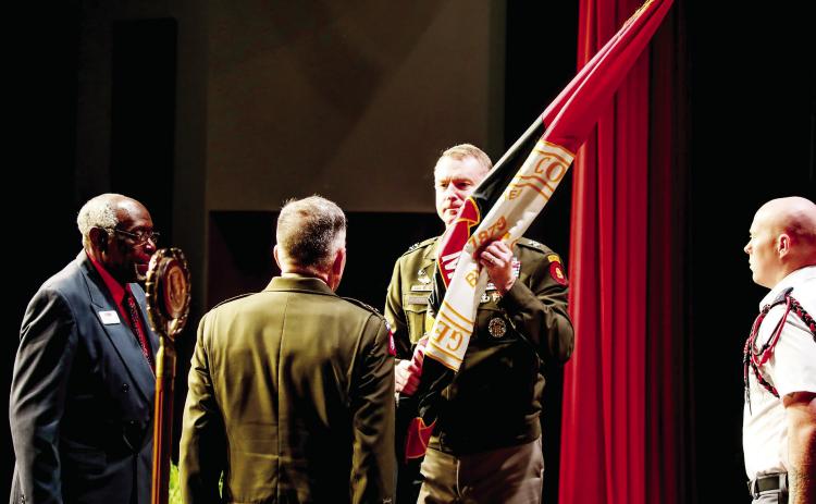Former Georgia Military President Lt. Gen. William B. Caldwell, IV (back facing) passes the Georgia Military College colors to new GMC President Maj. Gen. Terrence J. McKenrick during the Change of Command ceremony Aug. 8 in the NewDay USA Center of Leadership. COURTESY OF GMC