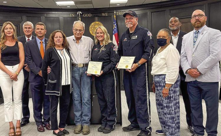Baldwin County Commission Chairman Andrew Strickland awarded Certificates of Recognition to pilot Don Heironimus (not pictured), flight nurse Melissa Michie, and paramedic James Caulfield for their life-saving efforts on April 4 that ensured the survival of Lynn Chappell (left center). COURTESY OF AIR EVAC LIFETEAM 102 FACEBOOK