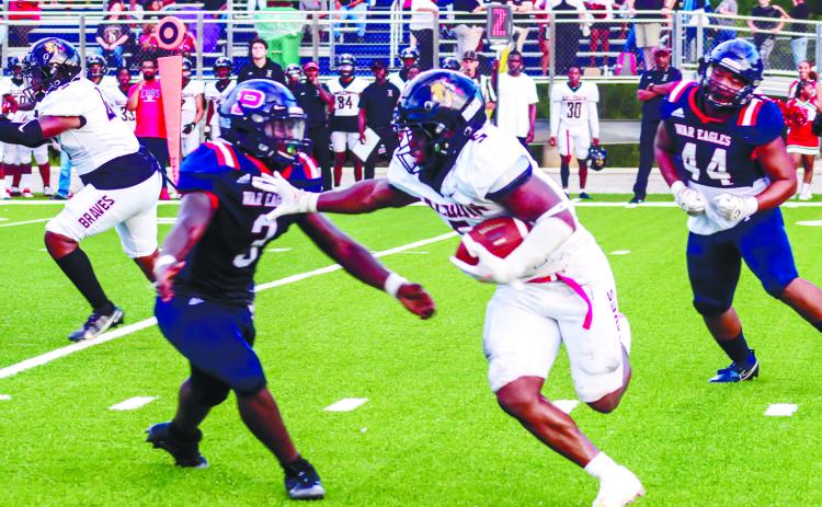 Micah Welch (4) stiff arms a Putnam defender in the loss to the War Eagles earlier this month. He ran for 215 yards on 29 rush attempts with two TDs against Washington County this past Friday. ARELLA CASH/Staff