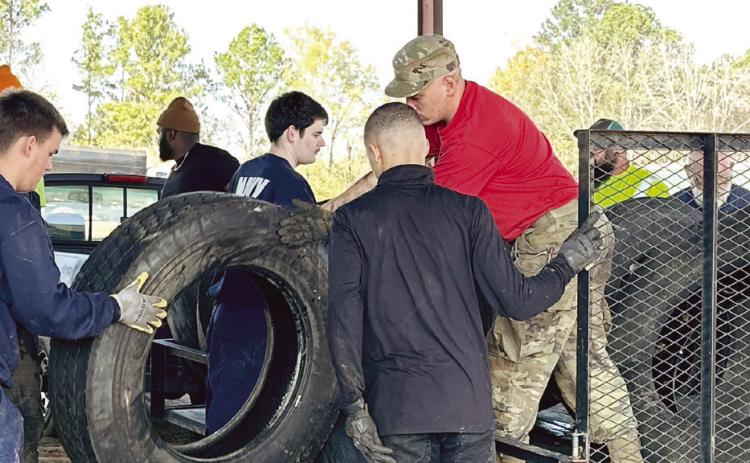 Volunteers and employees from Public Works unloaded tires from trailers. ALIVIA BLANTON/Staff