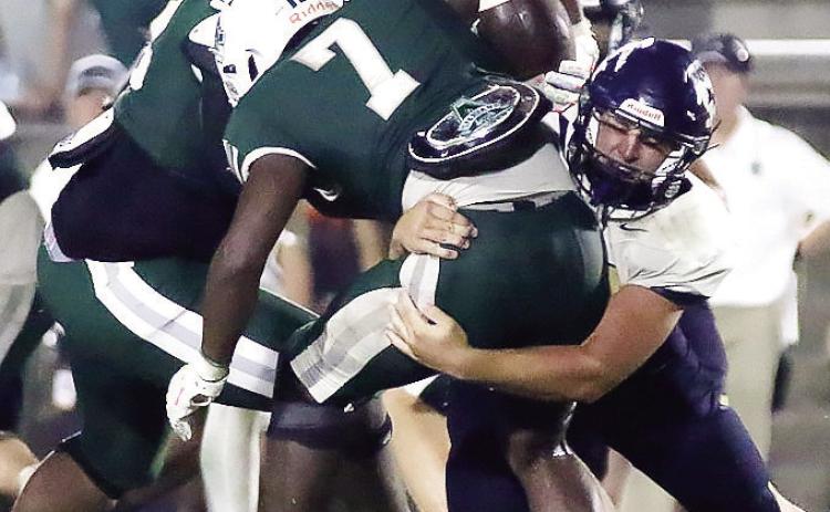 JMA’s Cohen Brooks tackles an Athens Academy ball carrier during last week’s game. TREY NORRIS/Staff