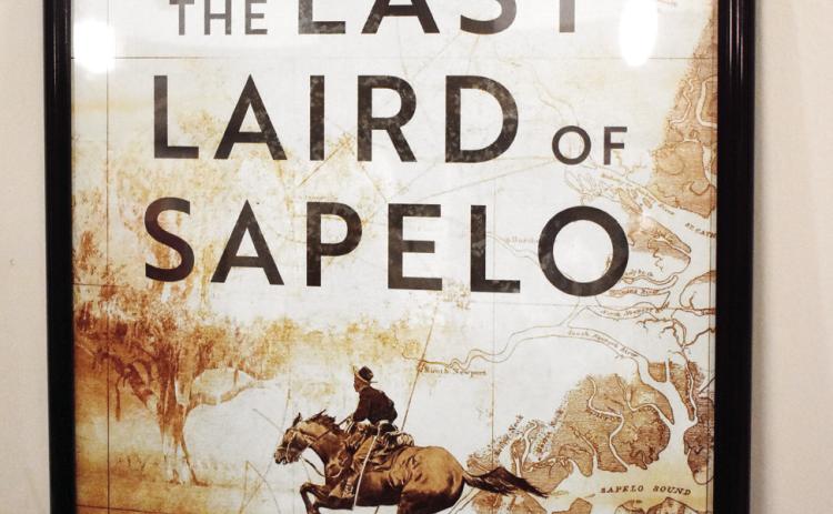 A poster of the cover of Brown’s novel The Last Laird of Sapelo that was on display during his book talk. BAILEY MCCULLY/Staff