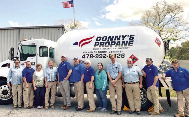 Donny’s Propane employees gather around one of the propane trucks for a photo at the company. ADAM SEGERS/Contributed