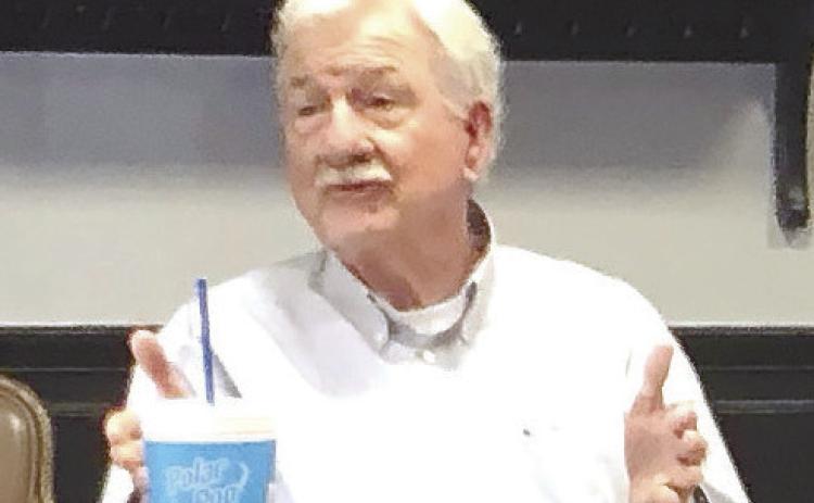 County commissioner Henry Craig makes a point about the hangar Monday. GREENBERRY MOORE/Staff