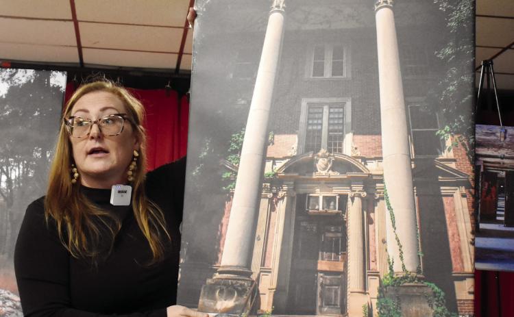 Seeking Asylum photographer Jessica Whitehead holds a picture of the Jones Building as she explains her journey with photography and Central State Hospital’s history. BAILEY MCCULLY/Staff