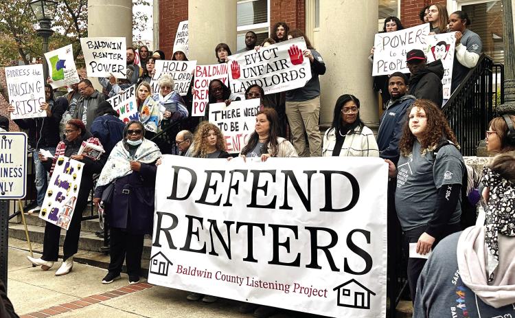 The Baldwin County Listening Project stands on the steps of City Hall to raise awareness of housing issues, following a housing survey the group recently completed. ALIVIA BLANTON/Staff