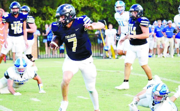 Quarterback Kolt McMichael (7) scrambles for a first down in the season opener against Brentwood. TREY NORRIS/Staff
