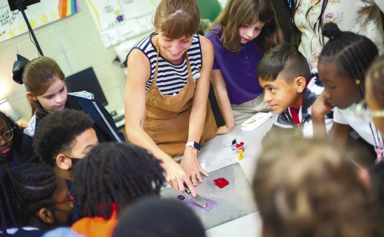 Megan Fowler, owner of Brown Parcel Press, teaches fifth grade students about art design. CONTRIBUTED