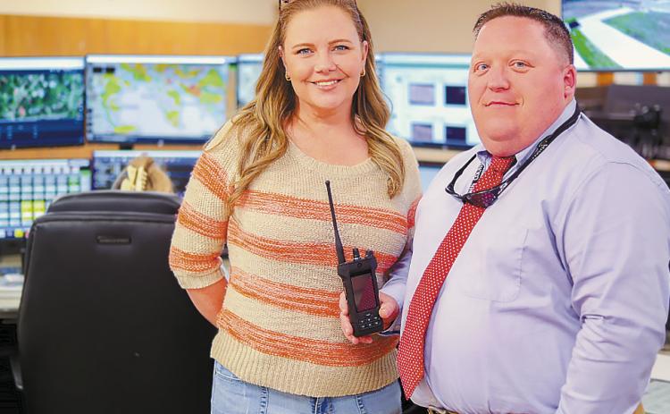 Director of Safety and Security Corey Goble (right) and Director of 911 Operations at the Baldwin County Sheriff’s Office Mandy Ptak show off one of the new radios. ERIC JONES/Contributed