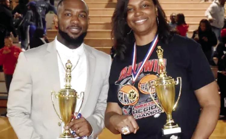 Coaches Ben Smith and Kizzi Walker hold the region trophies after their wins Feb. 14 at home. COURTESY OF BCSD FACEBOOK