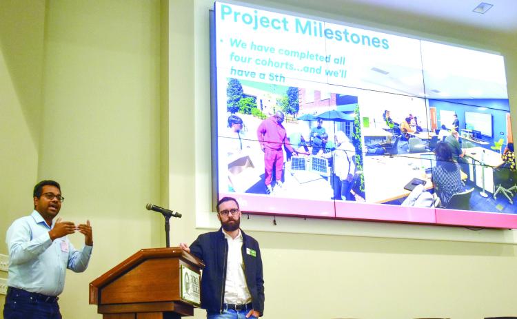Georgia College professors Dr. Hasitha Mahabaduge and Dr. Nicholas Creel present their Partnership of Inclusive Innovation project at the Creative Showcase hosted in GCSU’s Peabody Auditorium. BAILEY MCCULLY/Staff