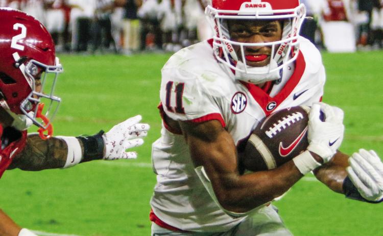 Georgia wide receiver Arian Smith (11) hauls in a 47-yard pass from quarterback Carson Beck during the fourth quarter of this past week’s game against Alabama. LANCE McCURLEY/Staff