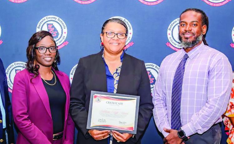 Baldwin High School Principal Markeeta Clayton (center) accepts the 2024 Platinum Award for Greatest Gains. CONTRIBUTED