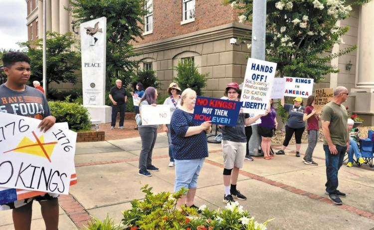 About 30 people gathered for a ‘No Kings’ protest in downtown Milledgeville on Saturday, June 14, at the intersection of Hancock and Wilkinson streets. CONTRIBUTED