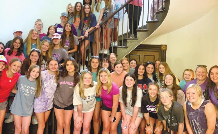 Students stand on the beautiful 197-year-old elliptical cantilevered staircase designed by John Marlor. CONTRIBUTED
