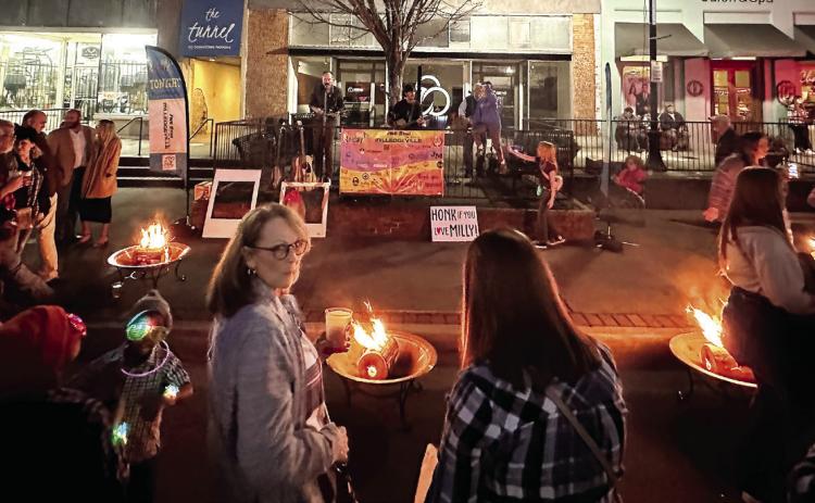The public gathered to listen to music by Local Folk Band while warming themselves by the fire. ETHAN MOLLENAUER/Staff