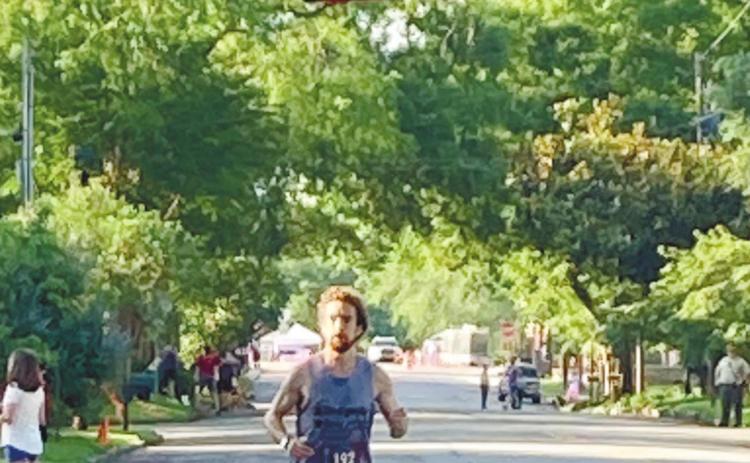John Green, of Milledgeville, the overall winner of the Dairy Festival 5K, comes in with no other runners visible behind him. LYNN HOBBS/Staff