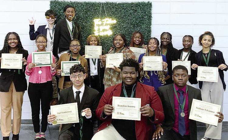 Students who attended the Georgia Speaking Competition pose with their awards. CONTRIBUTED