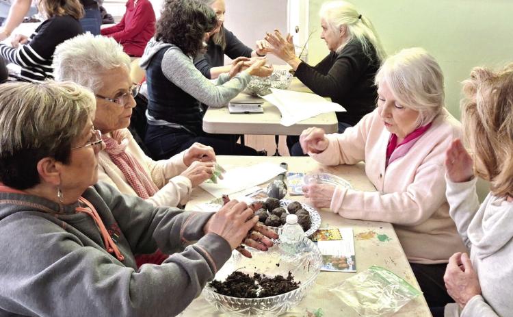 Milledgeville Garden Club President Ana Edwards (front left) assists with creating floral arrangements for assisted living and veterans homes. CONTRIBUTED