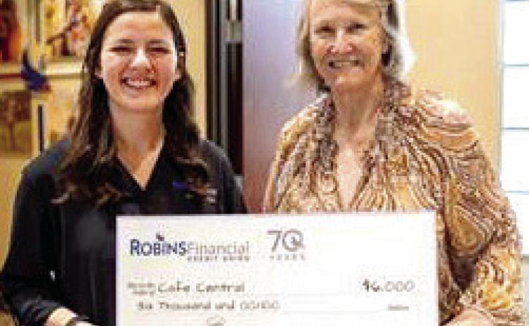Zabrina Kirby with Robins Financial Credit Union presents check to Ann Bowen with Cafe Central. CONTRIBUTED