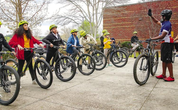 Oak Hill Middle School students learn teamwork through cycling as a community and assisting each other in activities that promote focus, communication and group safety. CONTRIBUTED