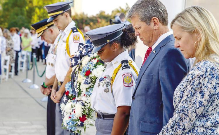 Georgia Gov. Brian Kemp bows his head during a prayer held on Sept. 11. BAILEY MCCULLY/Staff