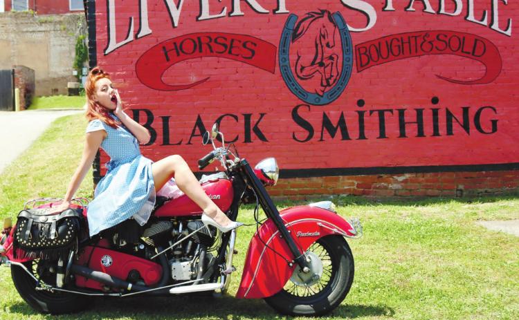 A member of Lifers Car Club poses with her motorcycle. ARELLA CASH/Staff