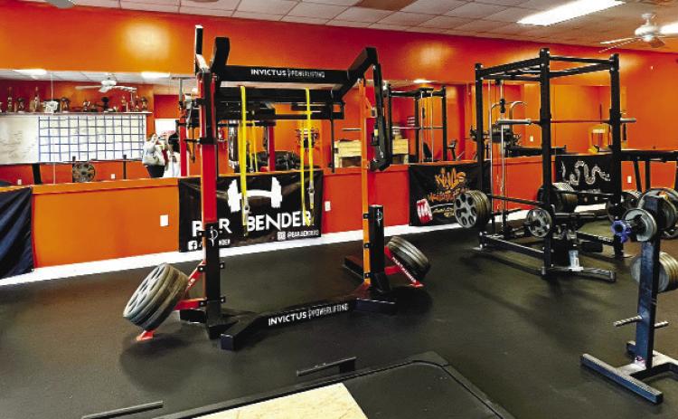 Heavy equipment for those who really enjoy testing their strength is set up in the back room of the gym.