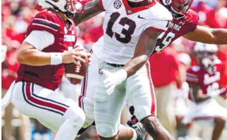 Georgia defensive lineman Mykel Williams (13) closes in on South Carolina quarterback Spencer Rattler (7) during