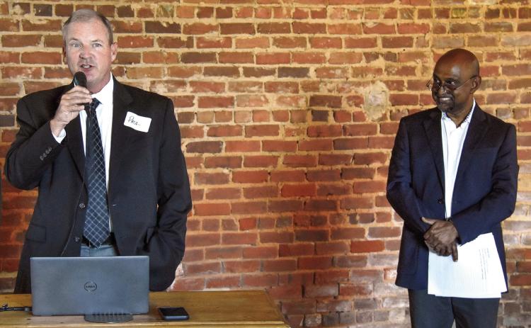 Putnam County Manager Paul Van Haute addresses the crowd at Barrel 118 while Habitat for Humanity of Putnam Executive Director Murali Thiramul looks on during the announcement of Carter Crossing, expected to begin construction next spring. IAN TOCHER/Staff