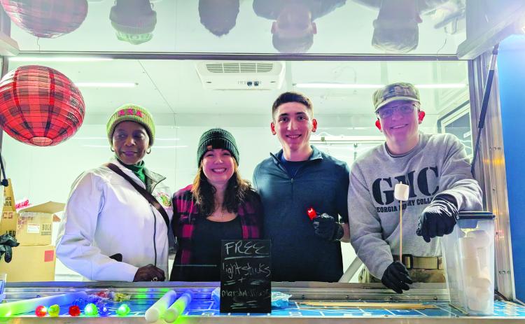 Amy Raburn with other members of North Rich Christian Church at First Friday. ANDREW BROWN/Staff