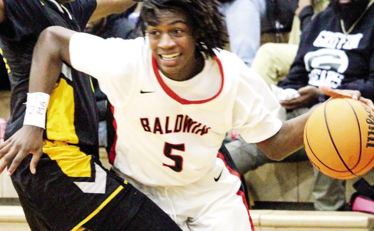 Baldwin’s Omari Woodard (5) fights to get past a defender in a recent Braves game. TREY NORRIS/Staff