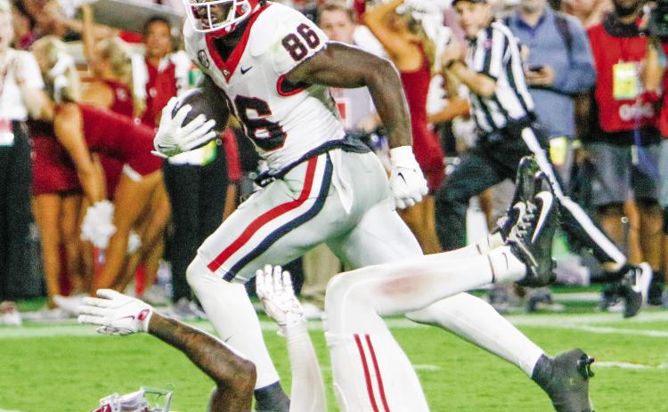 Georgia wide receiver Dillon Bell (86) runs over Alabama defensive back Keon Sabb (3) on his way to the end zone, giving the Bulldogs a 34-33 lead. LANCE McCURLEY/Staff