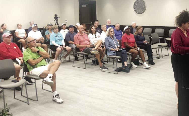The crowd attending the meeting watches as Grant Writer Nancy Hicks explains shift of grant funds to the Baldwin County Board of Commissioners. GREENBERRY MOORE/Staff