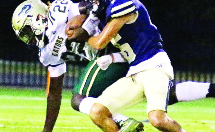 Players for John Milledge Academy (right) remain committed to fighting for every yard of turf as they prepare for playoffs. TREY NORRIS/File photo
