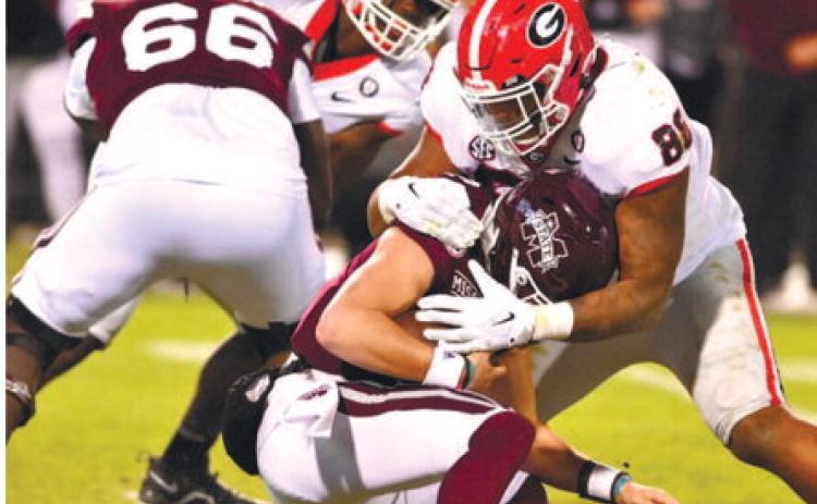 Georgia defensive linemen Jalen Carter (88) sacks Mississippi State quarterback Will Rogers during Saturday’s game in Starkville, Miss. ROB DAVIS/UGA Athletics