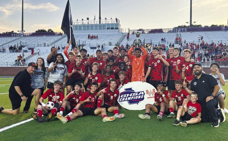 The Georgia Military College Prep soccer team poses with its GHSA State Championship trophy after a 3-1 victory over Atkinson County at Matthew Fields at Upson-Lee. Photo courtesy GHSA Facebook
