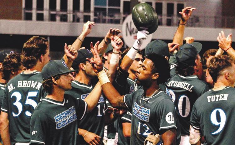 Players swarm senior KC Brown following his tenth inning walk-off home run in game one of the PBC Championship Tournament. COURTESY OF GC ATHLETICS
