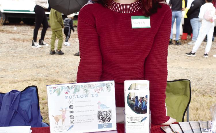Andalusia Institute employee Nevaeh Jones tabled at the artisans market to teach attendees about creative writing opportunities through a local grant program. She was one of several vendors present to add an educational component to the event.