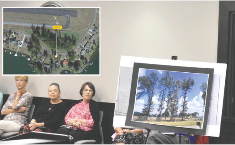 Citizens gathered at a meeting of Baldwin County Commissioners to express opposition to trees being cut down (as seen in photo displayed) as part of the county’s airport expansion project. Inset: a measurement shows that the airport is within 500 feet of private property, potentially raising a legal question. BAILEY McCULLEY/Staff