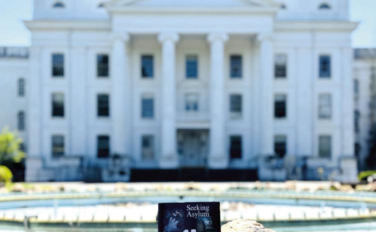 Seeking Asylum, by Jessica Whitehead, sits in front of the Central State Hospital Powell Building, which is featured on the cover of the book. CONTRIBUTED