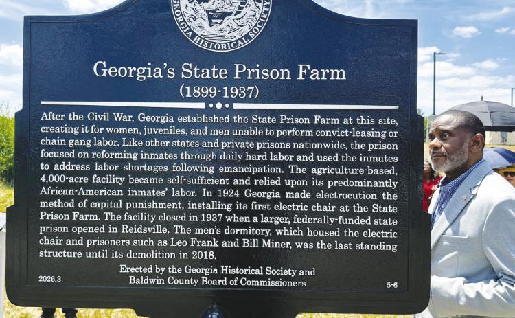 County Commissioner Kendrick Butts gets a first glance at Baldwin County’s newest Georgia Historical Society marker during a ceremony on Tuesday. CHRISTIAN McKEARNEY/Staff