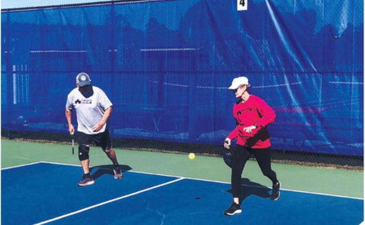 Ellen Paulish serves as partner Steve Franks moves forward. GREENBERRY MOORE/Contributed