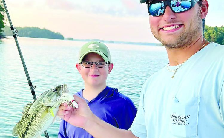 Beau and Ryan with a spotted bass. CONTRIBUTED
