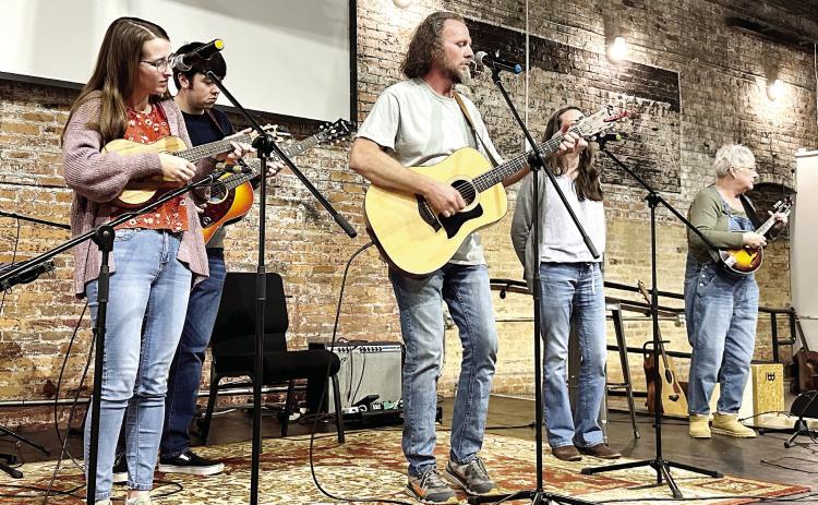 Georgia-based folk duo “Good House” play on the main stage with some friends and family members ETHAN MOLLENAUER/Staff