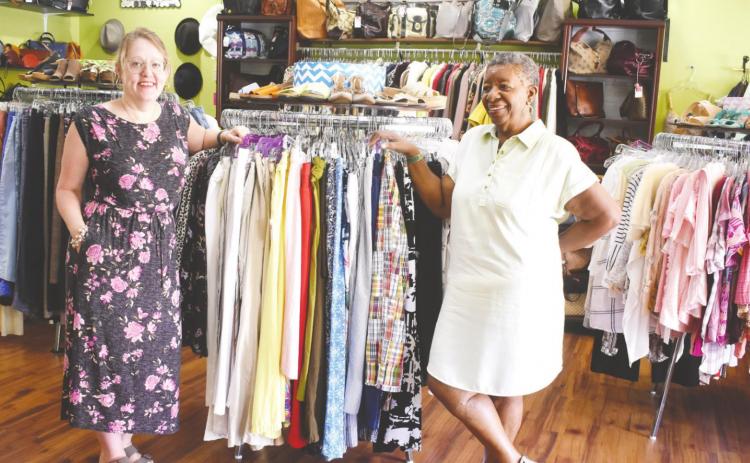 Owner Hiedi Martin and employee Von Williams pose with merchandise.