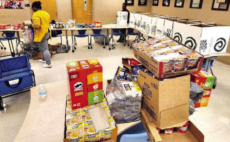 Baldiwn County’s Social Services and Family Engagement Departments unite each year to prepare meal boxes for students in need. This picture is from a distribution in 2023, after a state meal truck service was discontinued. CONTRIBUTED