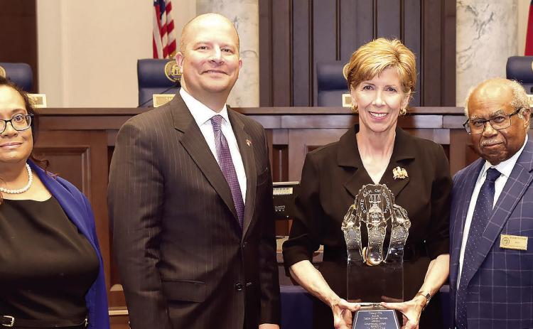 Retired Justice Robert Benham (right) was on hand April 15 in Atlanta when GCSU President Cathy Cox (with trophy) received a lifetime achievement award during the 25th annual Justice Robert Benham Awards for Community Service. CONTRIBUTED